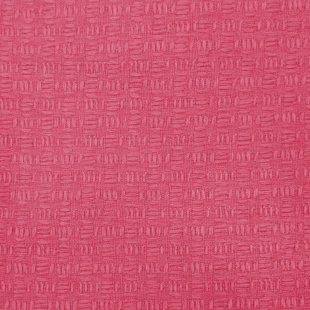 Bright raspberry pink textured woven fabric with a small geometric grid pattern