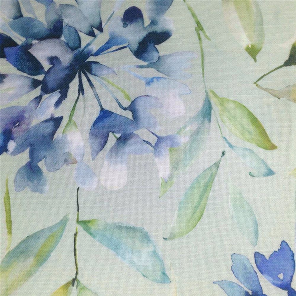 Watercolour blue floral fabric with pale green leaves on a light ground