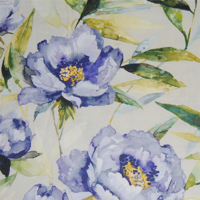 Painterly blue floral fabric with lilac blooms, green leaves and pale ground