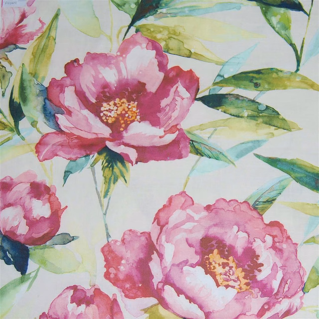 Watercolor pink floral fabric with large blooms and green leaves on a pale ground