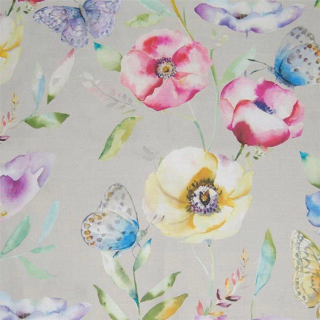 Pastel floral and butterfly fabric on a pale ground with pink, blue and yellow accents