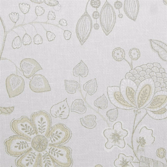 Cream embroidered floral fabric with pale sage leaf and blossom motifs