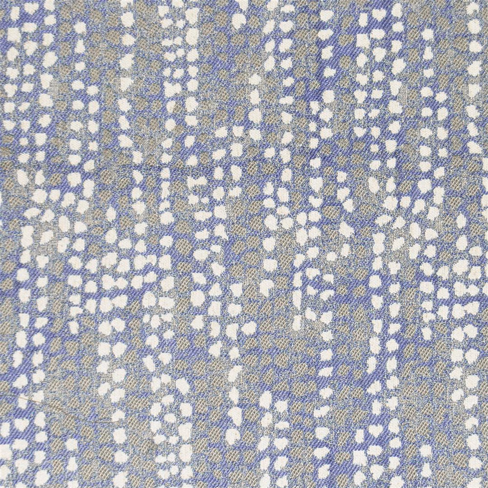 Blue and ivory abstract woven fabric swatch with pebble-like scattered spots