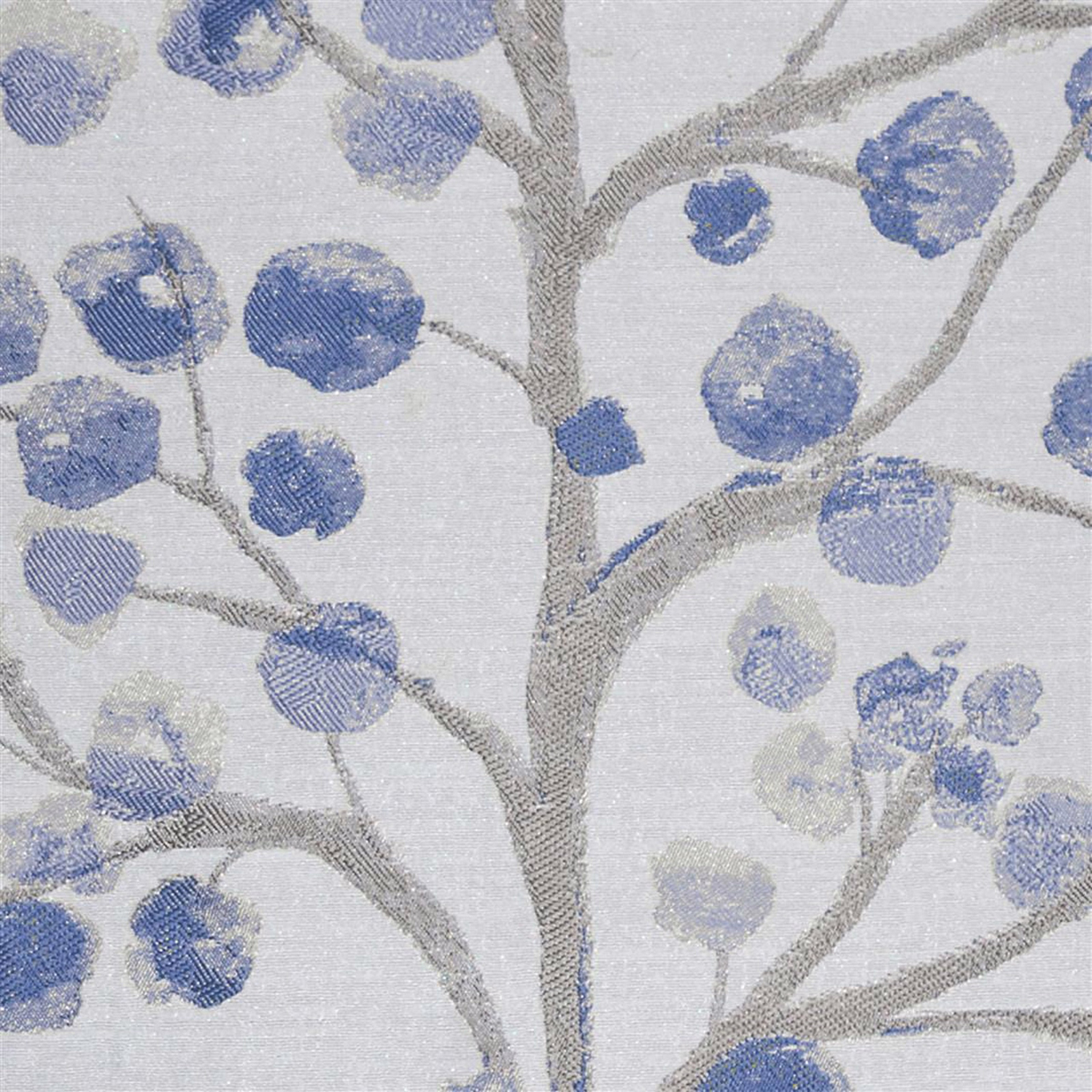 Blue berry motifs and grey branches on a pale silver woven fabric swatch