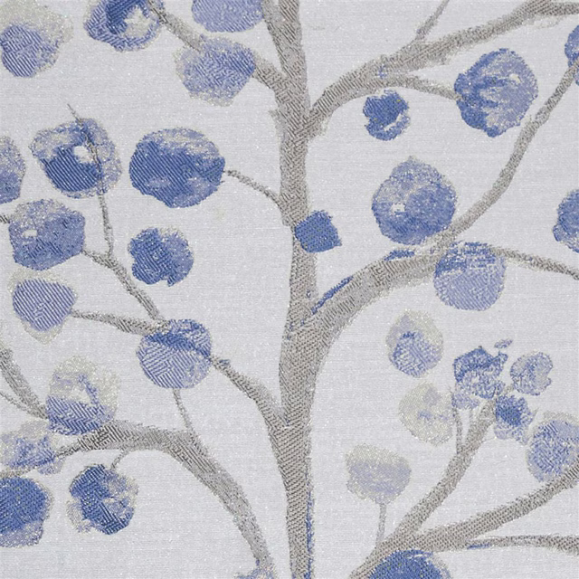 Blue berry motifs and grey branches on a pale silver woven fabric swatch