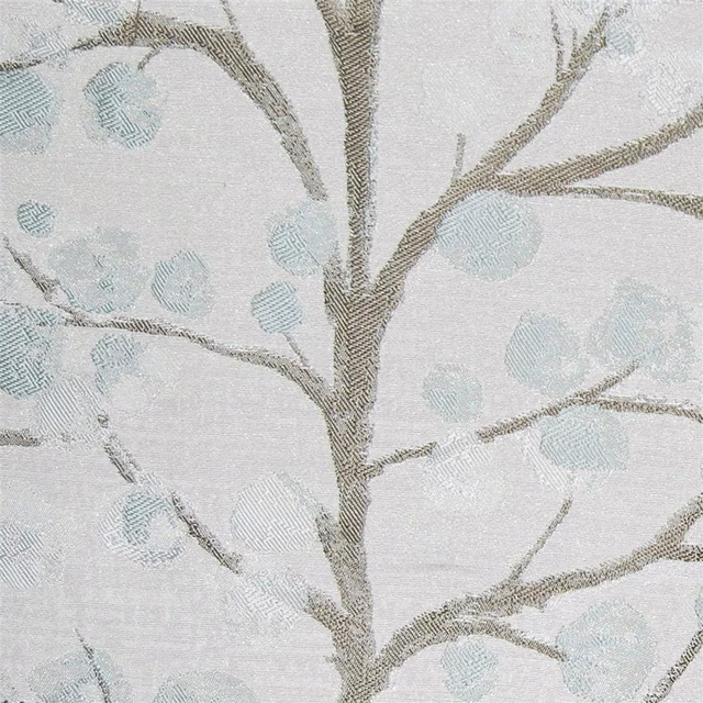 Grey botanical fabric swatch with taupe branches and pale blue circular leaves