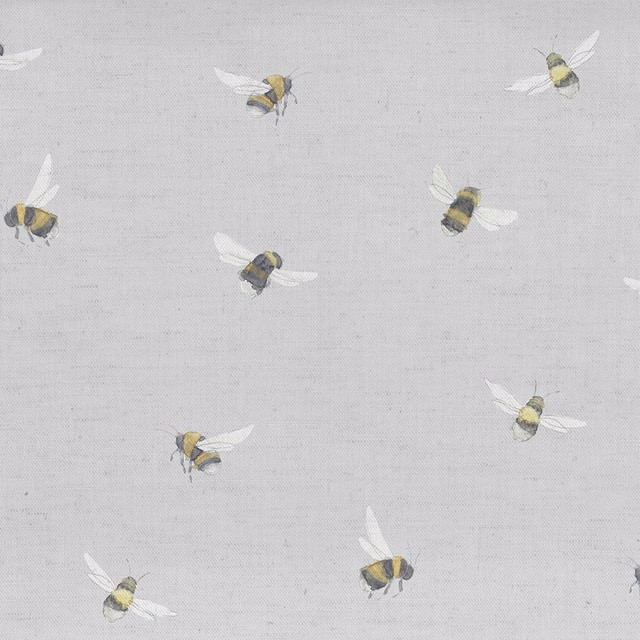 Grey fabric swatch with small bee motif in yellow, charcoal and white wings