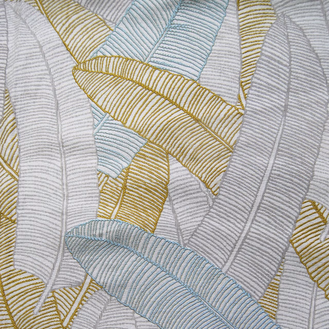 Close-up of Daxby Multi fabric showing pale grey woven leaf bands with gold and aqua accents