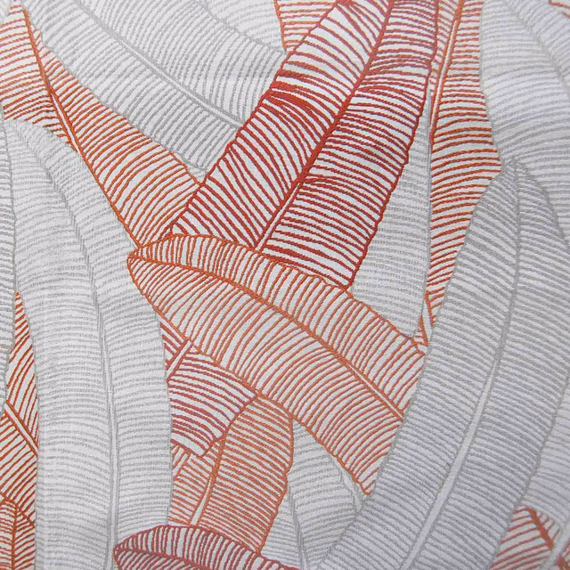 Embroidered leaf pattern in coral red and grey on a pale ground