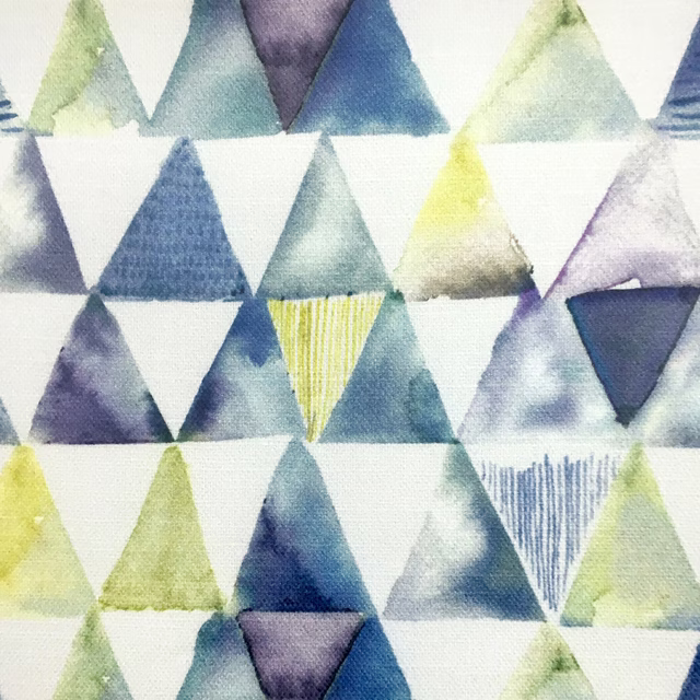 Geometric triangle fabric in soft yellow, blue, green and lilac on white
