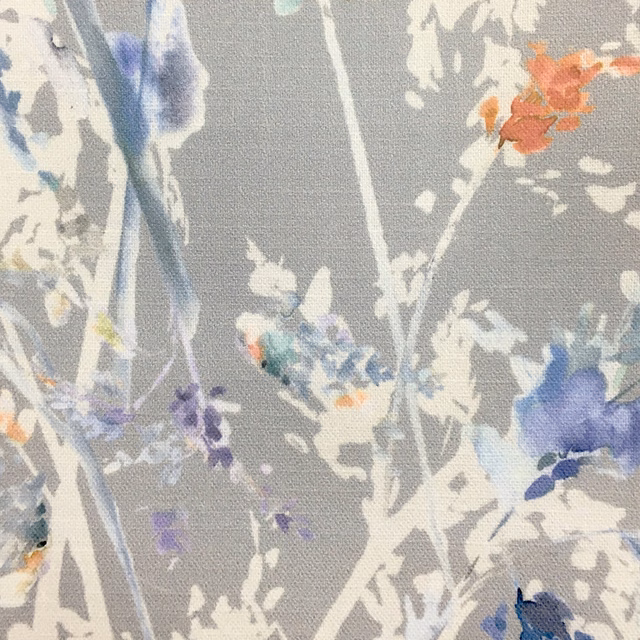 Grey botanical fabric swatch with painterly blue, lilac and white floral stems