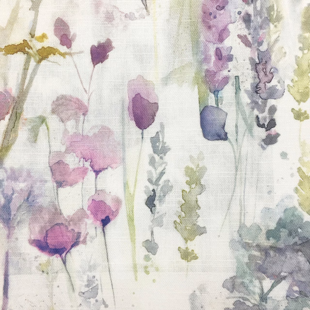Painterly lilac and mauve floral print on a pale textured ground