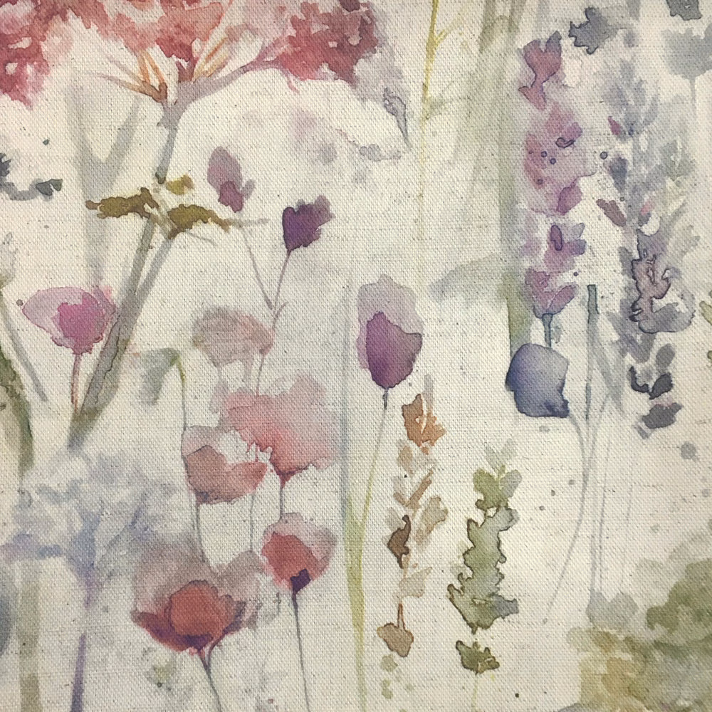 Painterly floral fabric with muted red, lilac and sage motifs on a pale ground
