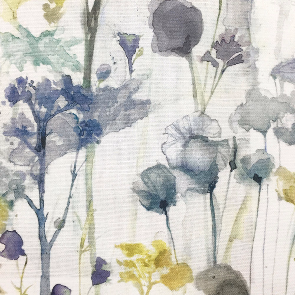 Painterly floral fabric on cream ground with muted yellow, blue, grey and green blooms