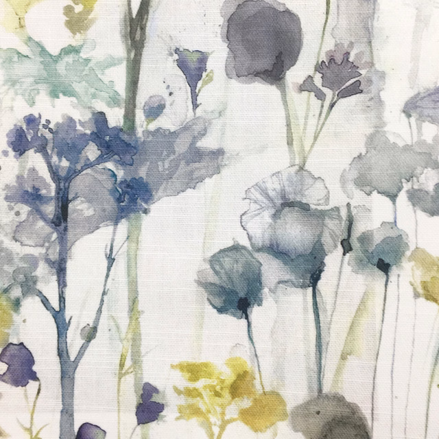 Painterly floral fabric on cream ground with muted yellow, blue, grey and green blooms