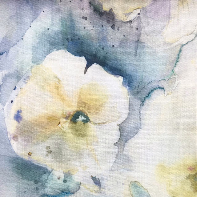 Painterly pale yellow flower on a soft blue-grey and ivory fabric swatch