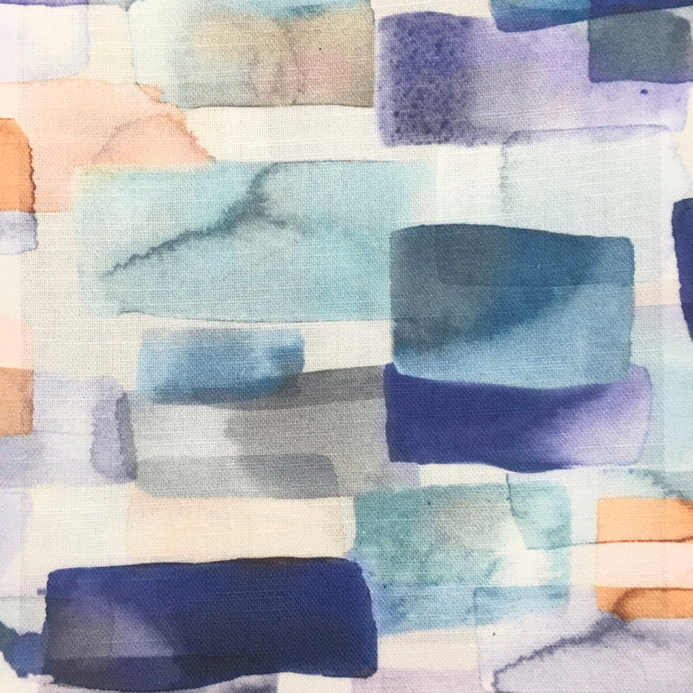 Painterly blue, aqua and indigo block-printed fabric swatch with pale cream ground
