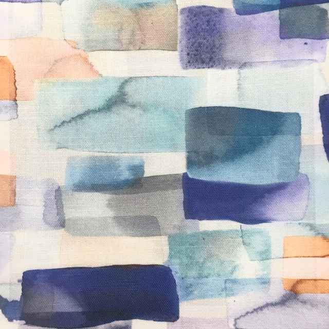 Painterly blue, aqua and indigo block-printed fabric swatch with pale cream ground