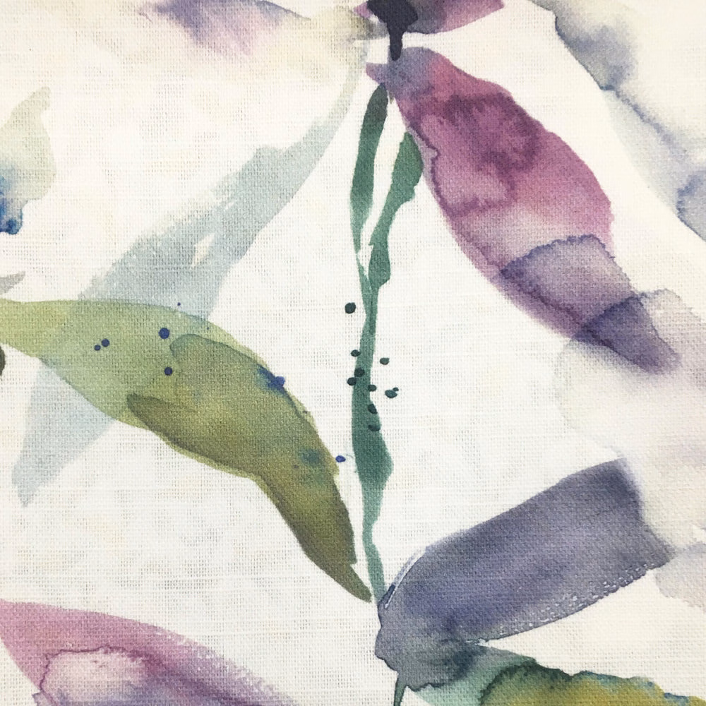 Painterly botanical fabric with pale blue-grey leaves, lilac accents and green stems