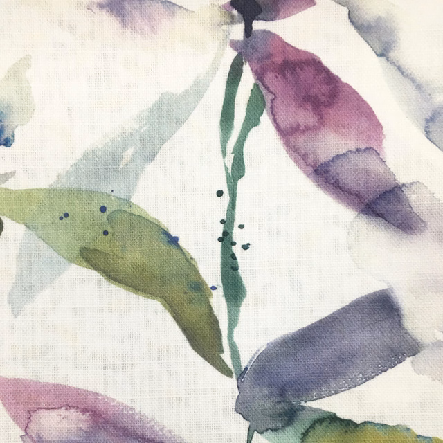 Painterly botanical fabric with pale blue-grey leaves, lilac accents and green stems