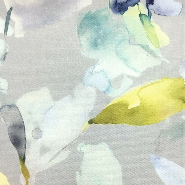 Abstract watercolor-style fabric with aqua, mint and yellow-green shapes on stone ground