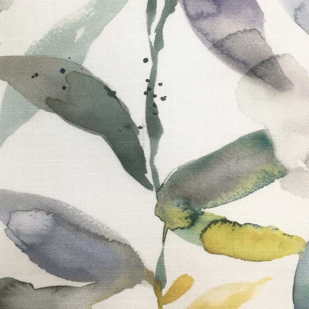 Painterly botanical fabric with muted yellow, sage green and grey leaves on a light ground