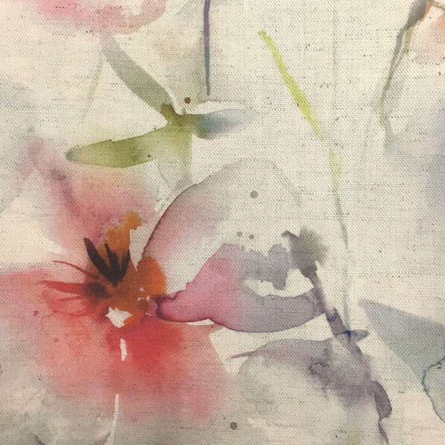 Painterly floral fabric with soft red, pink, green and grey blossoms on a pale ground