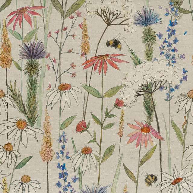 Floral meadow fabric on cream ground with pink, blue and green wildflowers