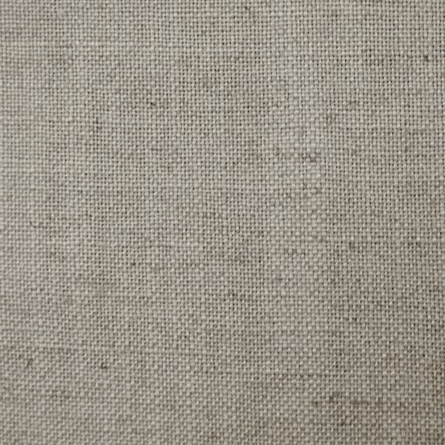 Close-up of warm cream plain weave fabric with fine linen-like texture