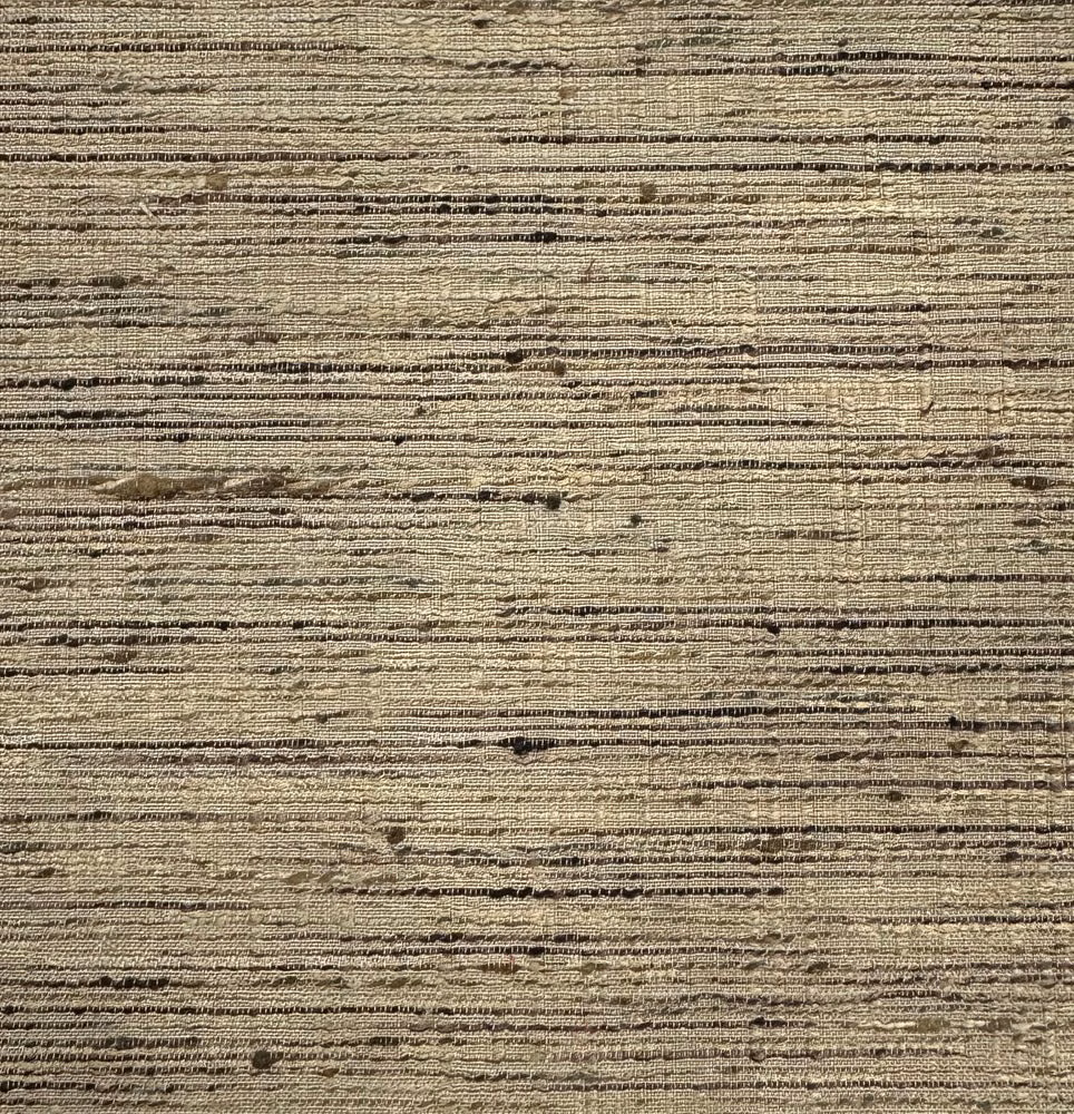Close-up of warm beige textured fabric with horizontal slubs and dark flecks