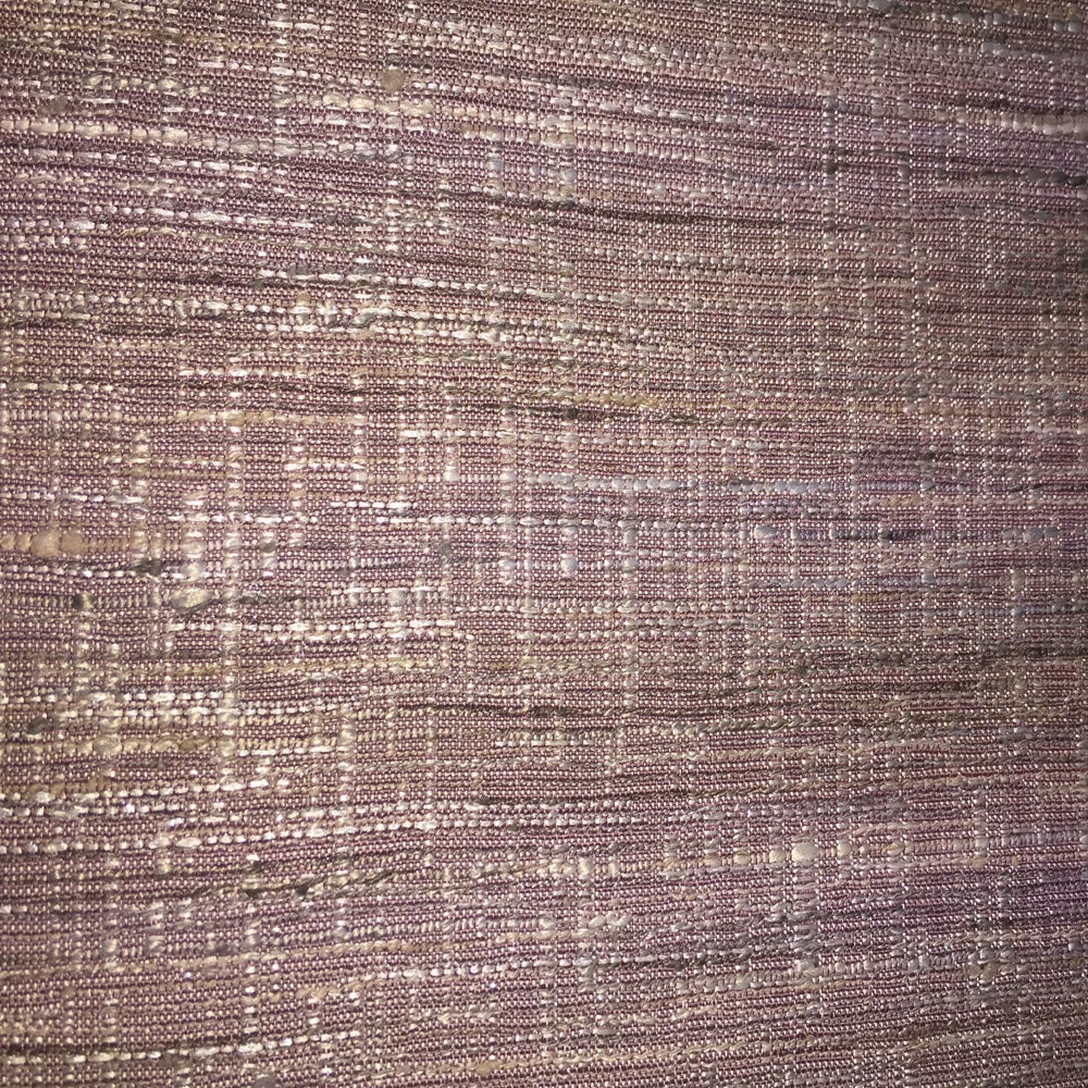 Close-up of muted dusty pink woven fabric with lilac and taupe highlights