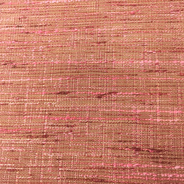 Close-up of a woven terracotta-red fabric with pink slubbed horizontal striations