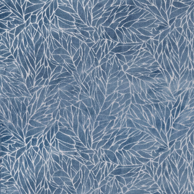 Blue botanical fabric with pale leaf outlines and a soft woven texture