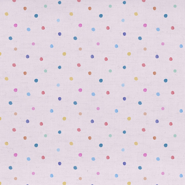 Pale blush pink fabric with scattered multicoloured polka dots on a fine woven ground