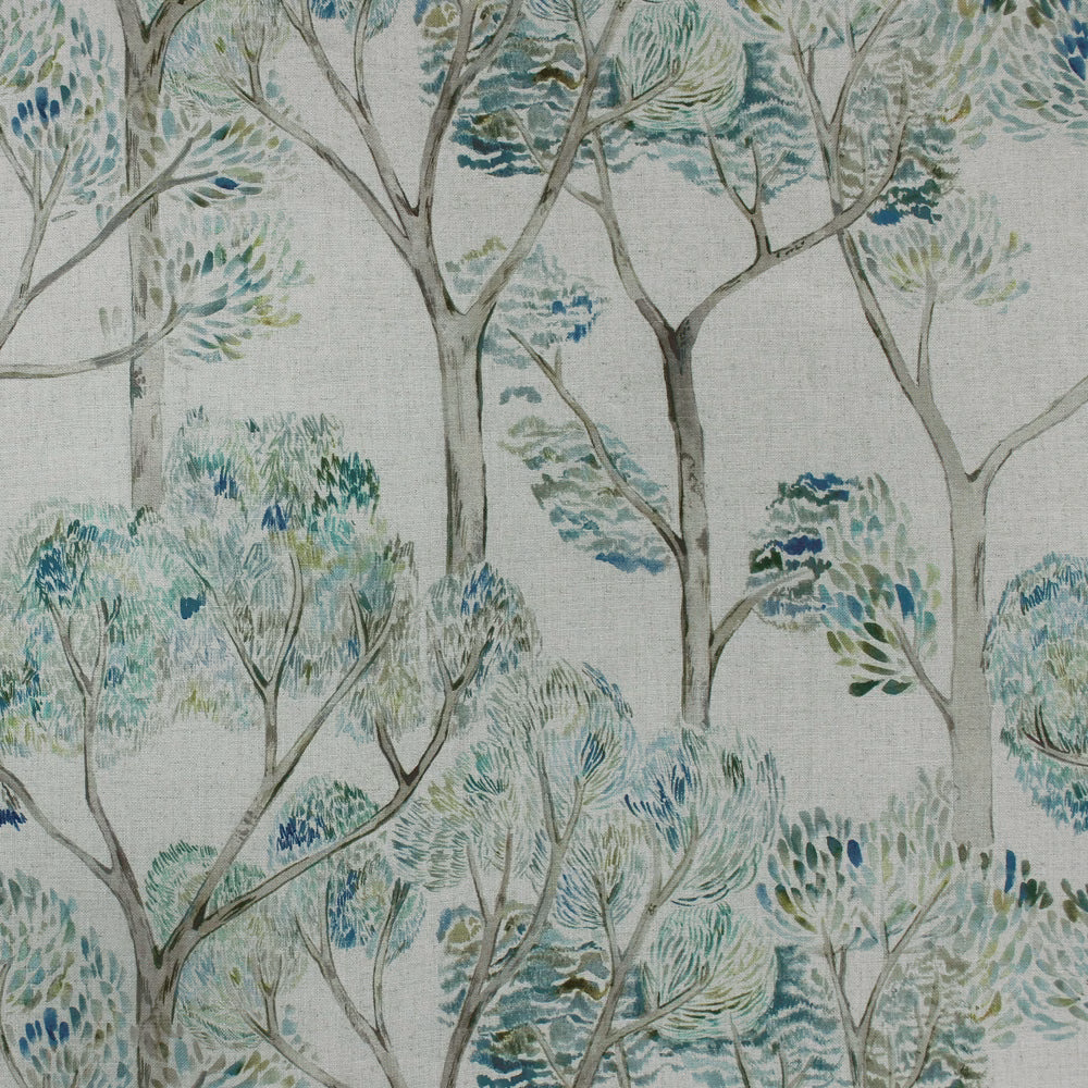 Painterly tree-and-leaf fabric in soft sage, teal and blue-green on a pale ground