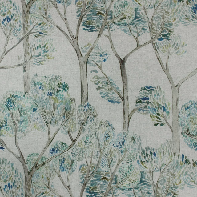 Painterly tree-and-leaf fabric in soft sage, teal and blue-green on a pale ground