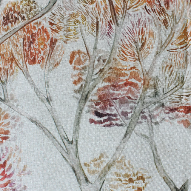 Botanical fabric swatch with rust orange foliage and pale grey stems on a cream ground