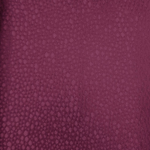 Deep berry pink textured fabric with small-scale woven abstract pattern