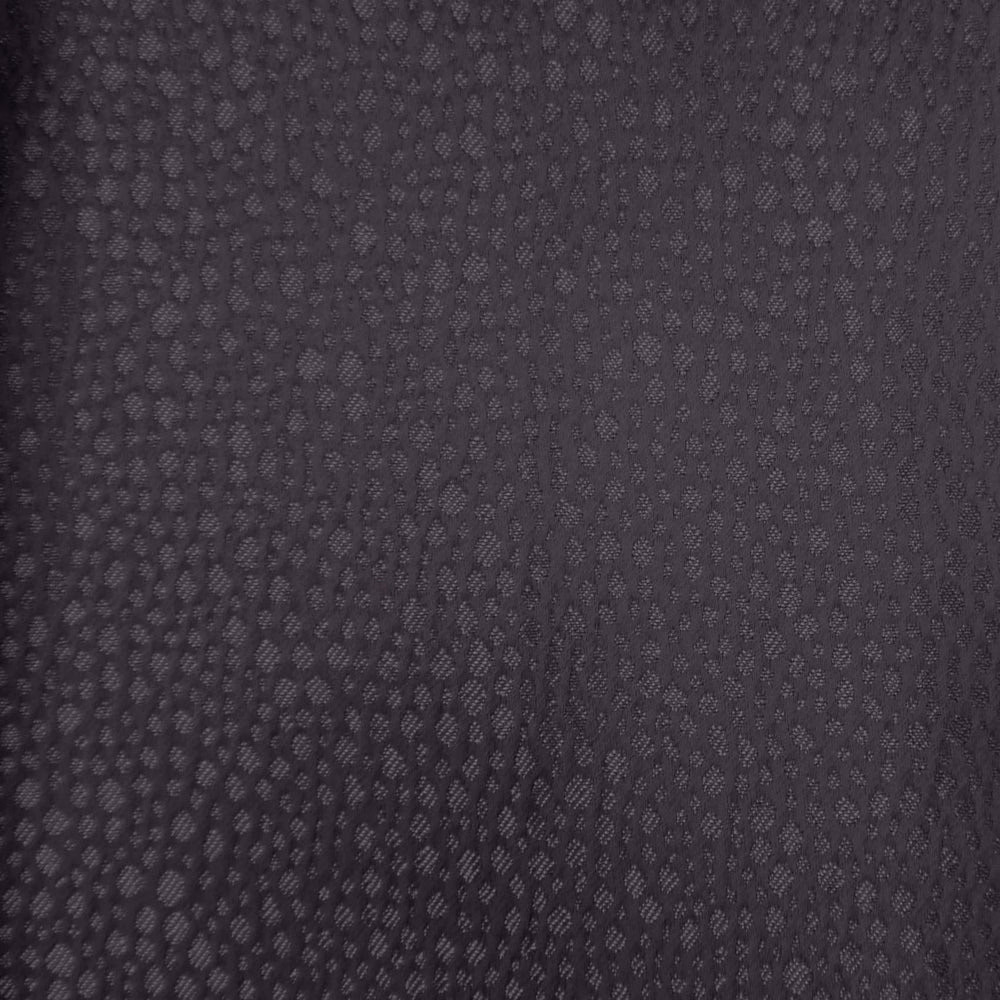 Close-up of dark plum-purple textured fabric with small all-over dot pattern