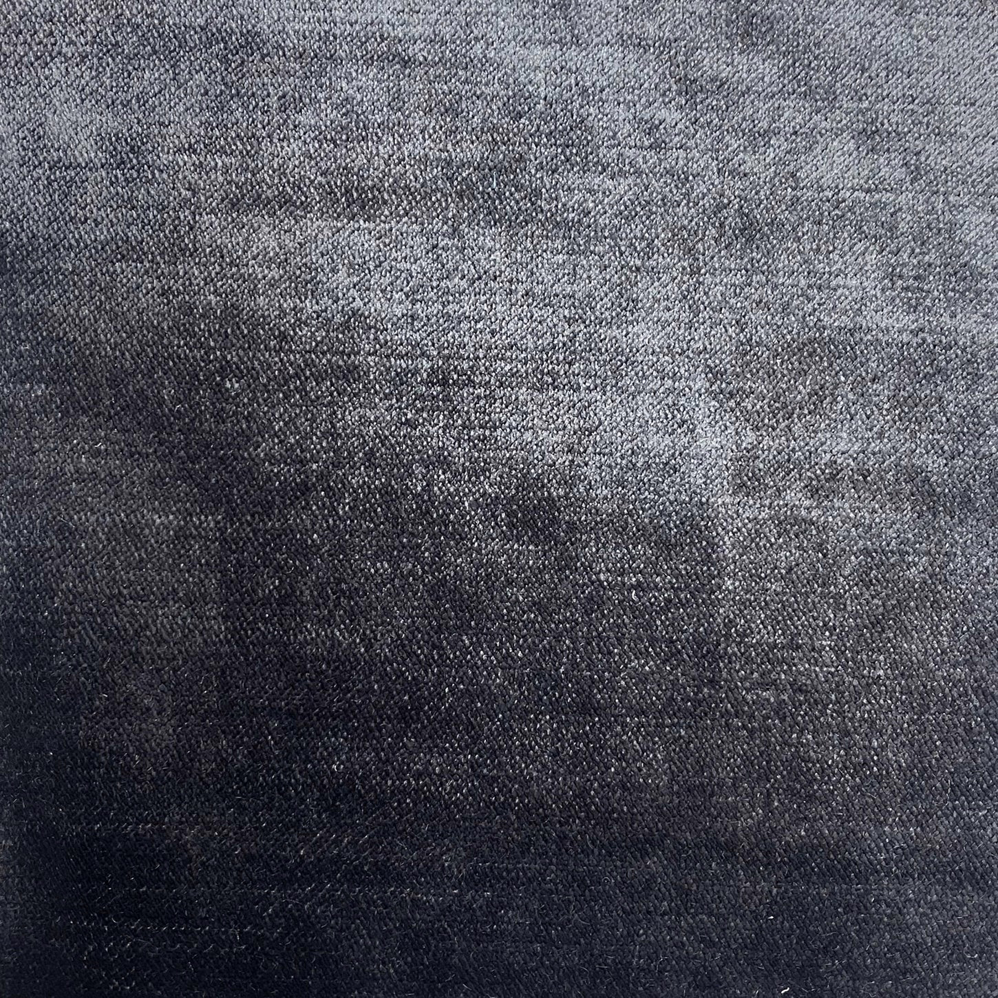 Close-up of a deep emerald grey textured woven fabric with subtle tonal shading
