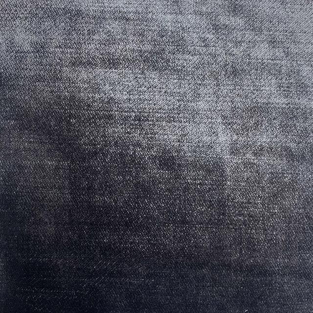 Close-up of a deep emerald grey textured woven fabric with subtle tonal shading