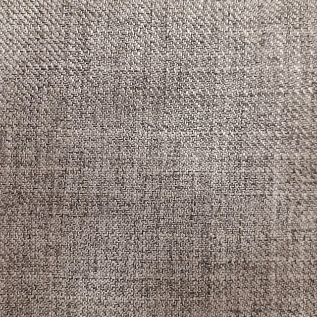 Close-up of warm beige woven upholstery fabric with a fine textured surface