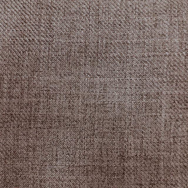 Close-up of warm taupe-brown woven fabric with a fine textured surface
