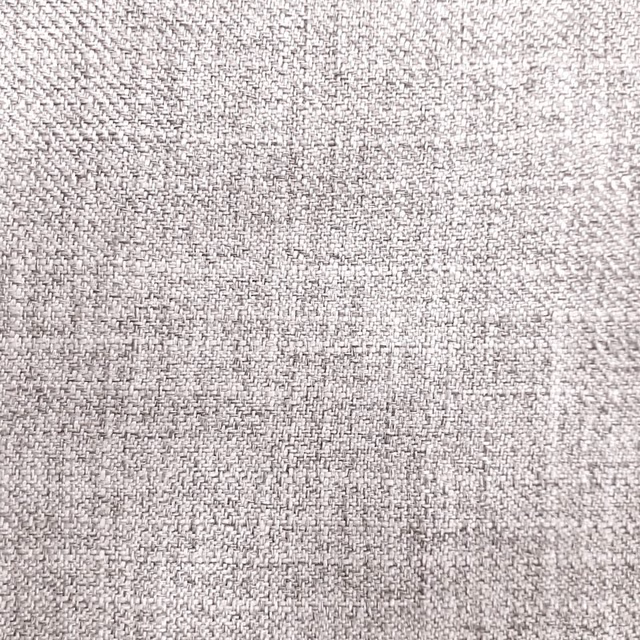 Close-up of a pale grey woven fabric with fine textured weave