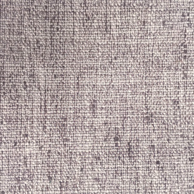 Close-up of a soft mauve-lilac woven fabric with speckled texture
