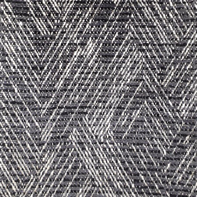 Close-up of a dark grey geometric woven fabric with pale zigzag stripes
