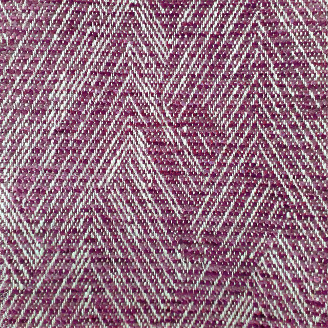 Close-up of a berry pink zigzag woven fabric with pale slub threads