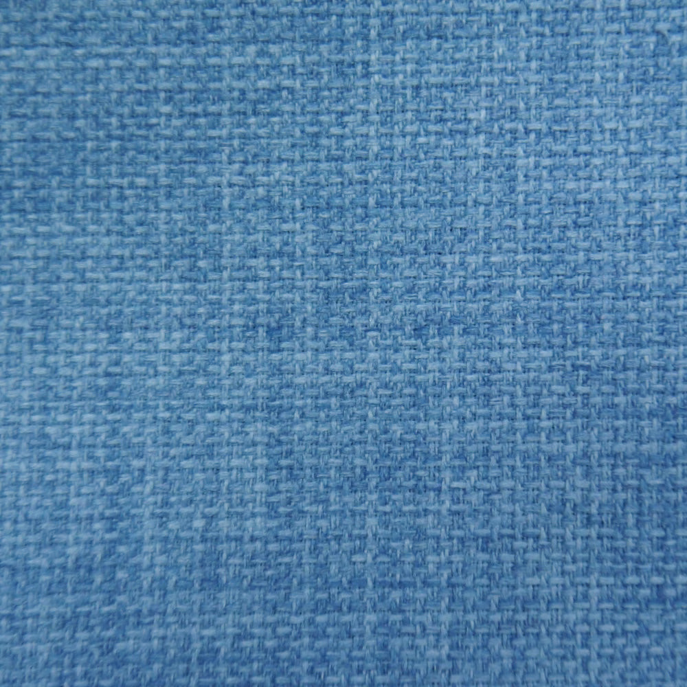 Close-up of soft denim blue woven fabric with fine textured weave