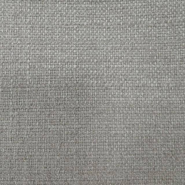 Close-up of a soft beige woven upholstery fabric with a subtle textured surface