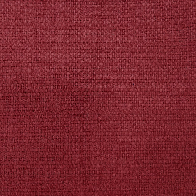 Close-up of deep raspberry red woven fabric with a textured basketweave surface